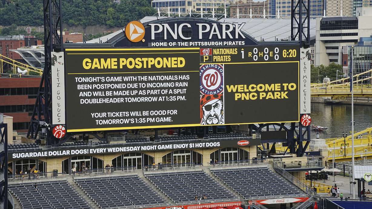 The scoreboard at PNC Park announces the postponement of a baseball game between the Pittsburgh Pirates and the Washington Nationals in Pittsburgh, Friday, Sept. 6, 2024. It will be played as part of a split doubleheader beginning a 1:35p Saturday, Sept 7, 2024.