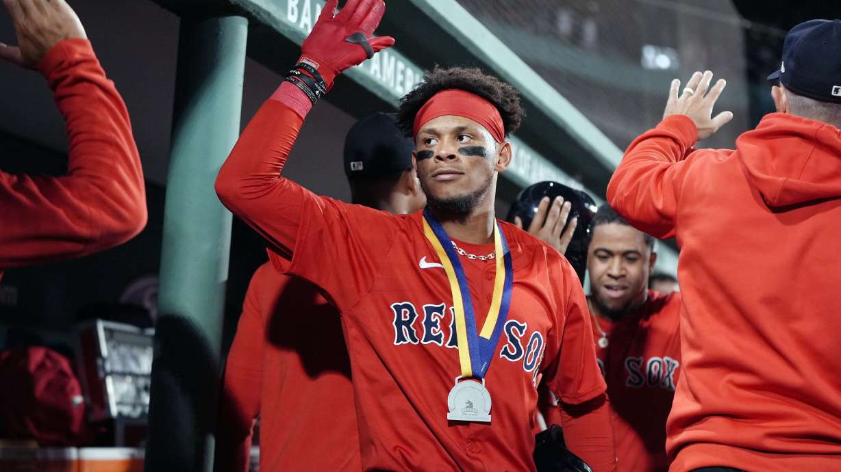 Boston Red Sox's Ceddanne Rafaela celebrates his two-run home run that also drove in Enmanuel Valdez, behind right, during the seventh inning of a baseball game against the Chicago White Sox, Friday, Sept. 6, 2024, in Boston.