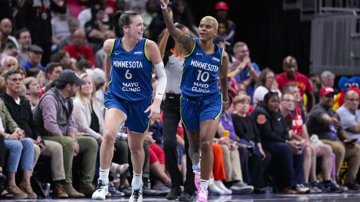 Minnesota Lynx guard Courtney Williams (10) and forward Bridget Carleton (6) celebrate after William hits a three-point basket against the Indiana Fever in the second half of a WNBA basketball game in Indianapolis, Friday, Sept. 6, 2024.
