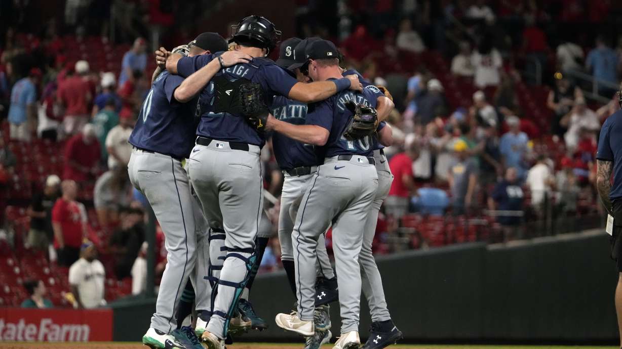 Members of the Seattle Mariners celebrate a 6-1 victory over the St. Louis Cardinals following a baseball game Friday, Sept. 6, 2024, in St. Louis.