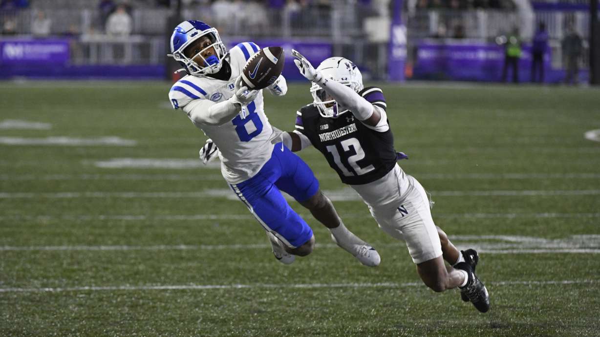 Northwestern defensive back Evan Smith (12) breaks up a pass meant for Duke wide receiver Jordan Moore (8) during the second half of an NCAA college football game, Friday, Sept. 6, 2024, in Evanston, Ill.