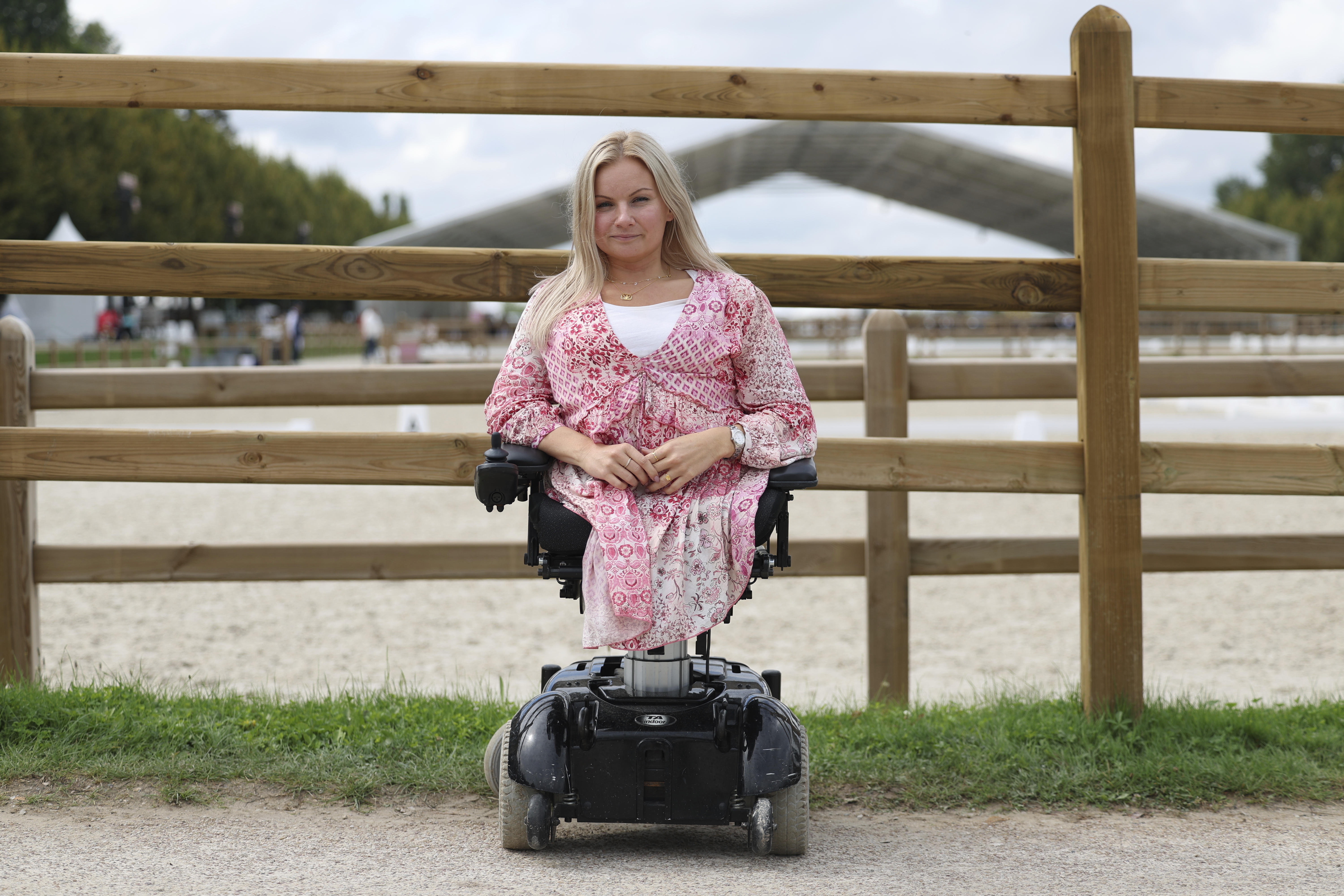 Stinna Tange Kaastrup of Denmark, a consultant for disability access for both the Olympic and Paralympic Games for the Versailles venue for Paris 2024, poses in front of the practice arena at Château de Versailles, Saturday, Sept. 7, 2024. 