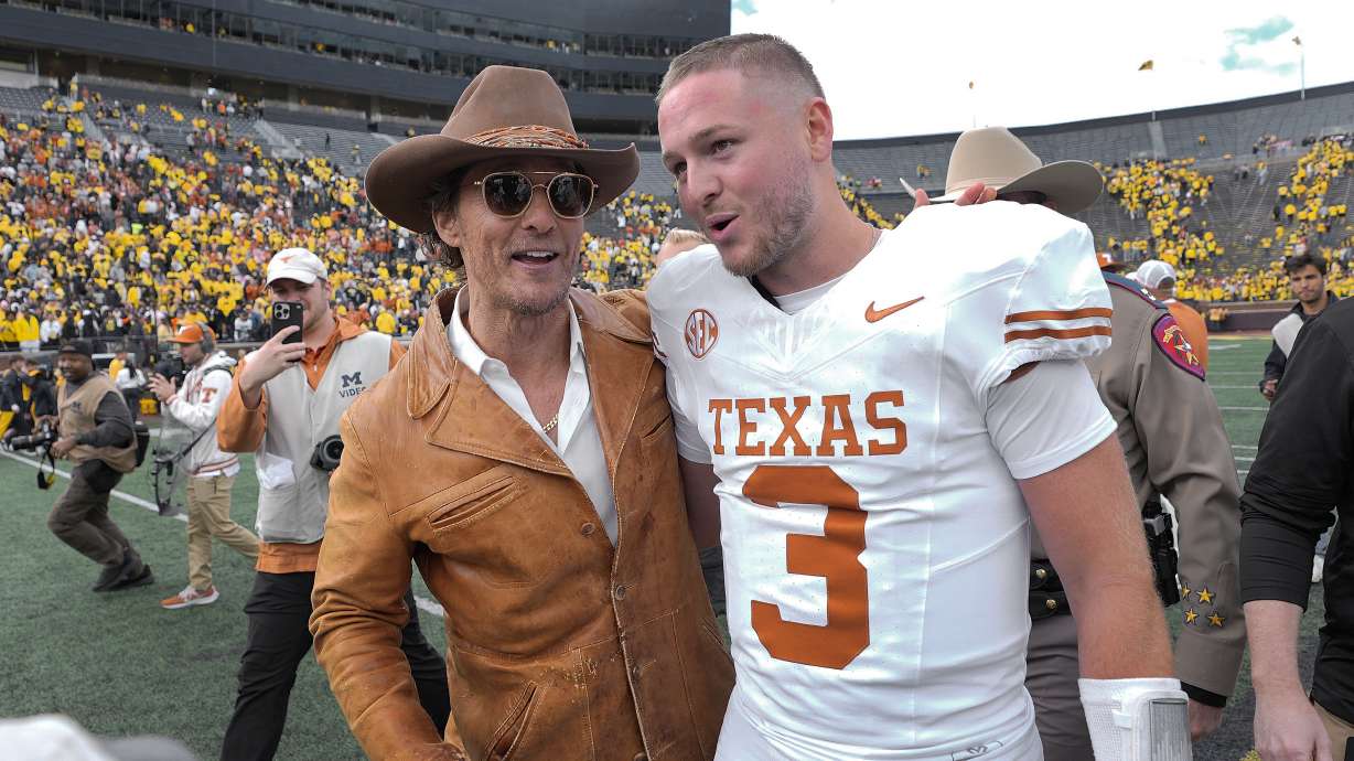 Actor Matthew McConaughey, left, celebrates with Texas quarterback Quinn Ewers (3) after an NCAA college football game against Michigan in Ann Arbor, Mich., Saturday, Sept. 7, 2024.