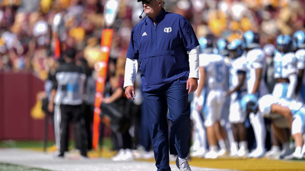 Rhode Island head coach Jim Fleming stands on the sideline during the first half of an NCAA college football game against Minnesota, Saturday, Sept. 7, 2024, in Minneapolis.