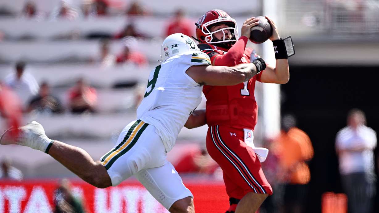 Utah Utes quarterback Cameron Rising (7) is driven out of bounds by Baylor Bears defensive lineman Treven Ma'ae (9) as Utah and Baylor play at Rice-Eccles Stadium in Salt Lake City on Friday, September 7, 2024.