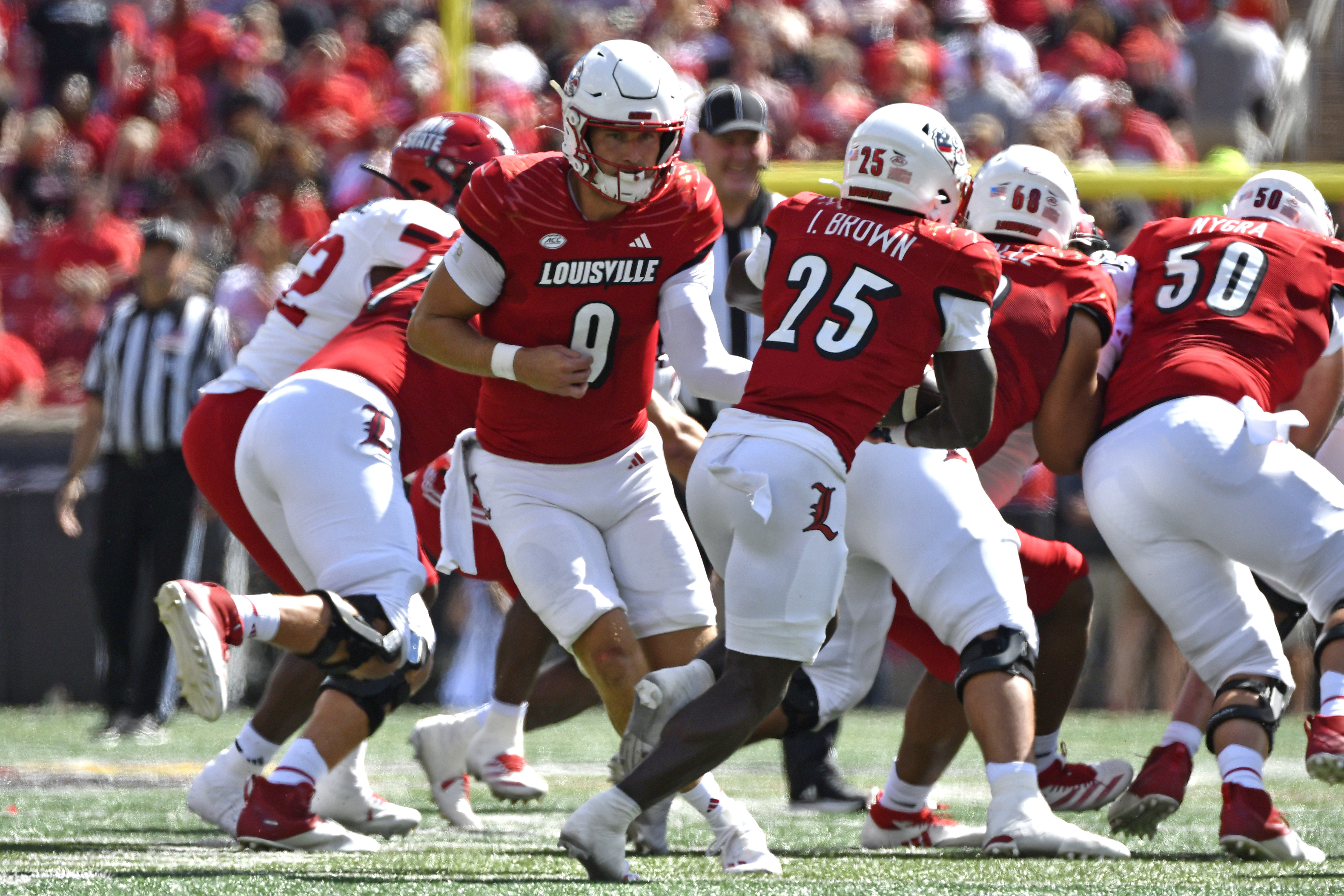 Louisville quarterback Tyler Shough (9) hands the ball off to running back Isaac Brown (25) during the first half of an NCAA college football game against Jacksonville State in Louisville, Ky., Saturday, Sept. 7, 2024.