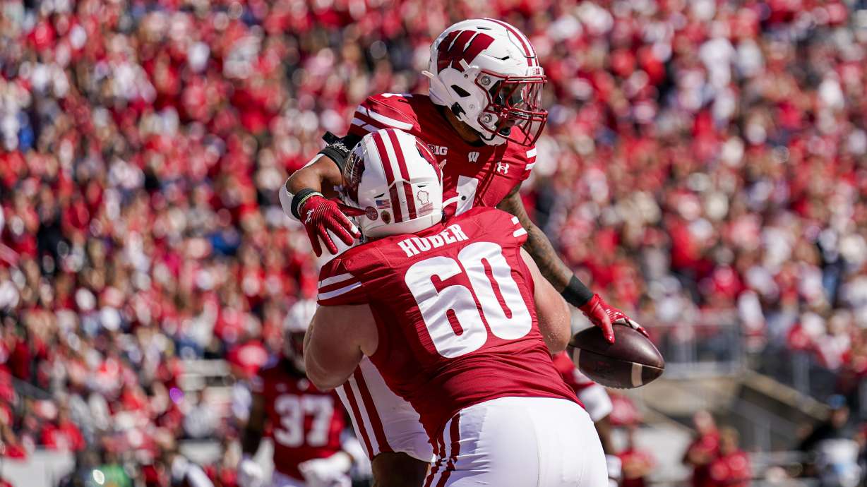 Wisconsin offensive lineman Joe Huber (60) congratulates running back Chez Mellusi on a touchdown against South Dakota during the first half of an NCAA college football game Saturday, Sept. 7, 2024, in Madison, Wis.
