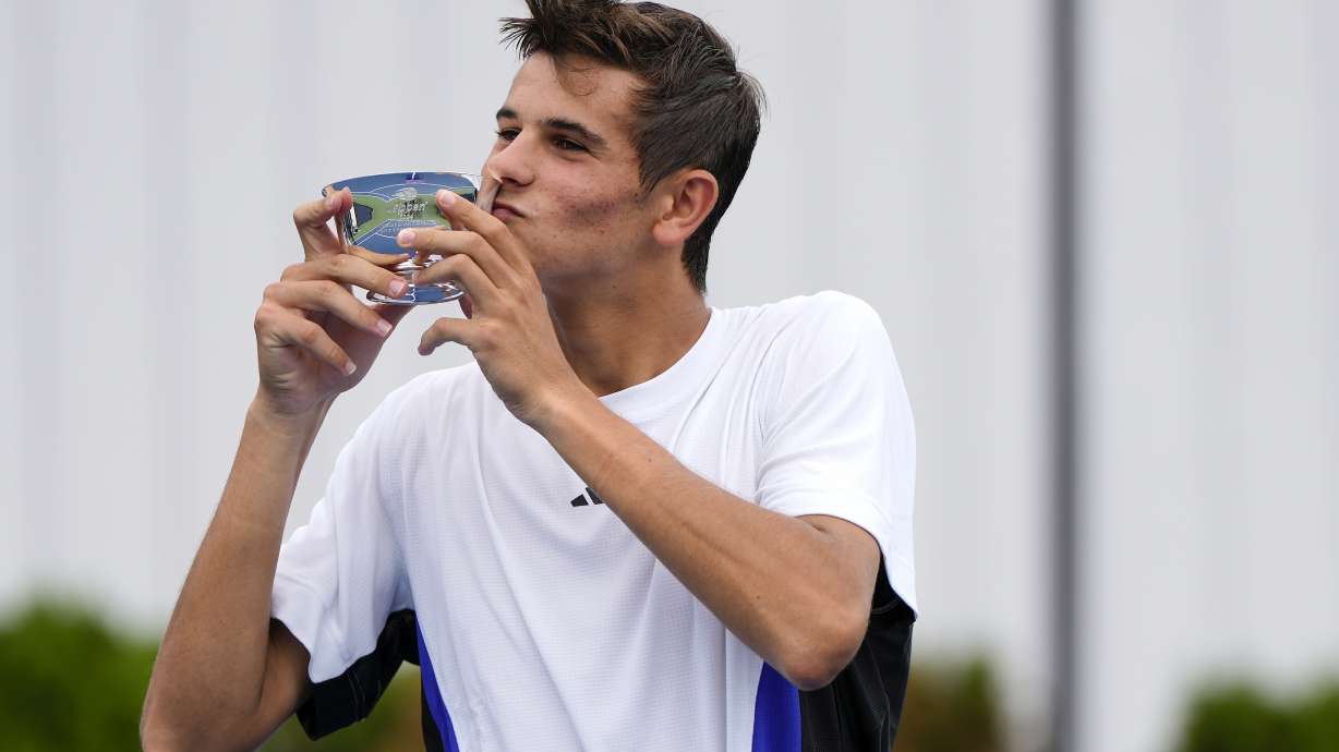 Rafael Jodar, of Spain, holds up the championship cup after defeating Nicolai Budkov Kjaer, of Norway, during the boy's singles final of the U.S. Open tennis championships, Saturday, Sept. 7, 2024, in New York.