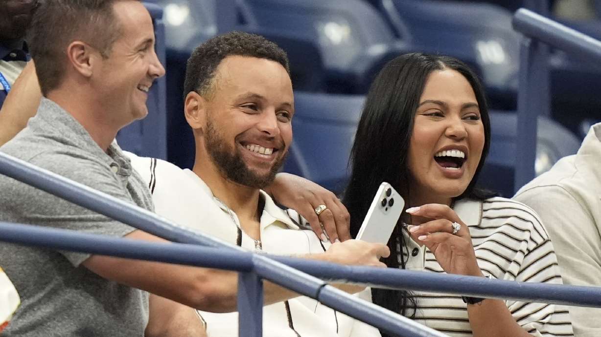 CORRECTS SPELLING OF FIRST NAME TO STEPHEN, NOT SPETH, ADDS WIFE's NAME - Stephen Curry, center, and his wife Ayesha Curry arrive for the women's singles final of the U.S. Open tennis championships between Aryna Sabalenka, of Belarus, and Jessica Pegula, of the United States, Saturday, Sept. 7, 2024, in New York.