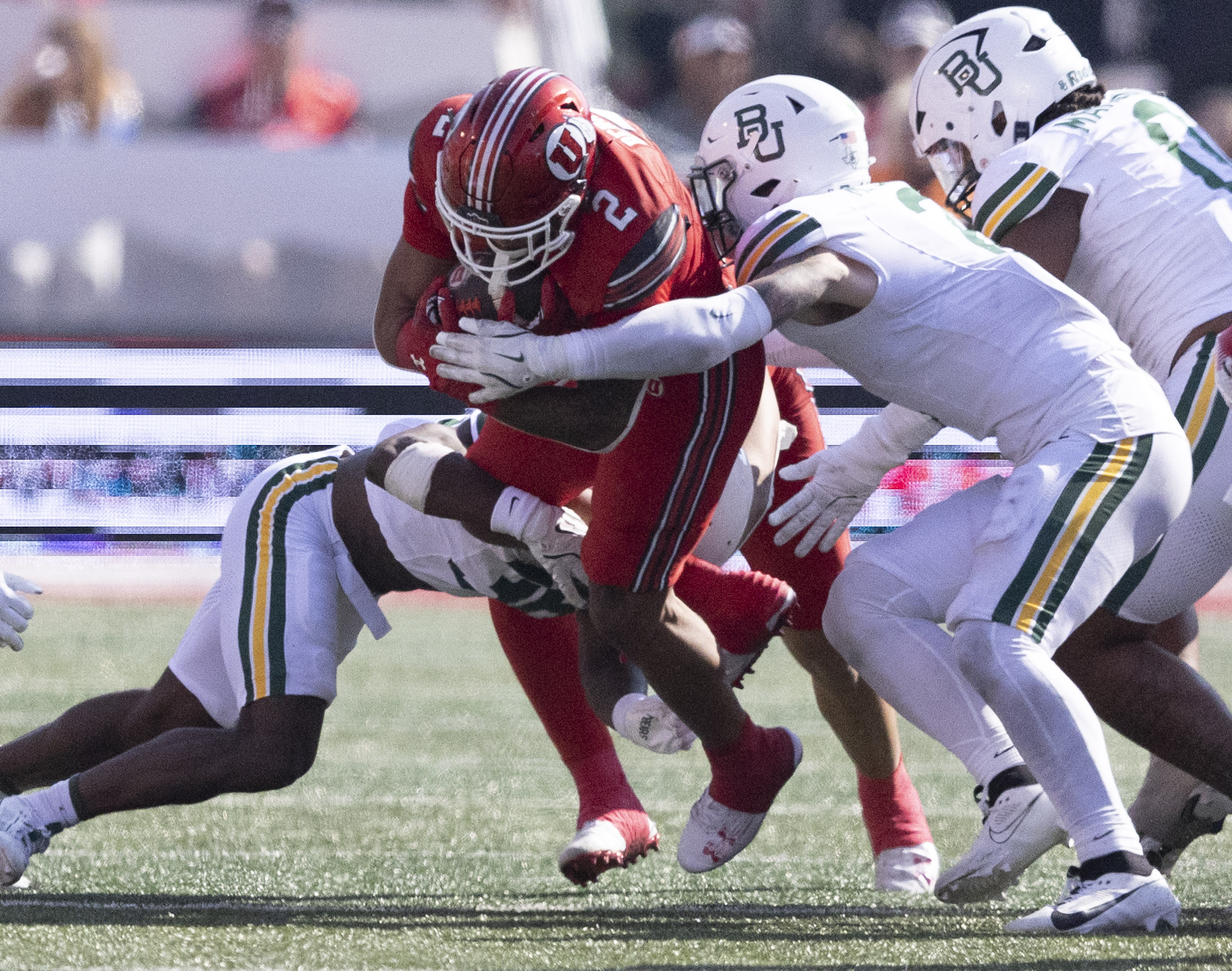 Baylor Bears linebacker Matt Jones (2) and Rara Dillworth (36) tackle Utah Utes running back Micah Bernard (2) at Rice-Eccles Stadium on the campus of the University of Utah in Salt Lake City on Saturday, Sept. 7, 2024. Utah went on to win the game  23-12.