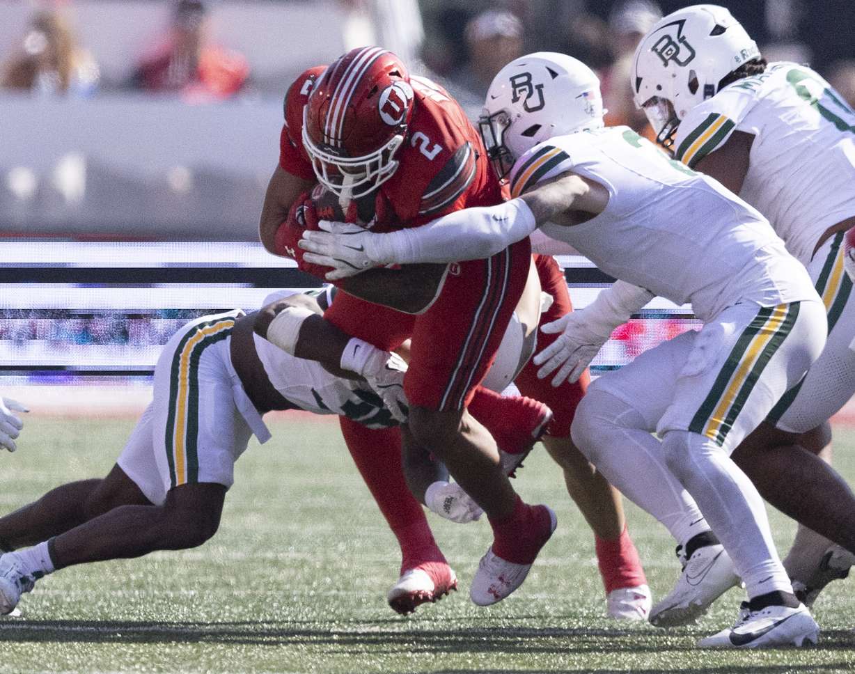 Baylor Bears linebacker Matt Jones (2) and Rara Dillworth (36) tackle Utah Utes running back Micah Bernard (2) at Rice-Eccles Stadium on the campus of the University of Utah in Salt Lake City on Saturday, Sept. 7, 2024. Utah went on to win the game 23-12.