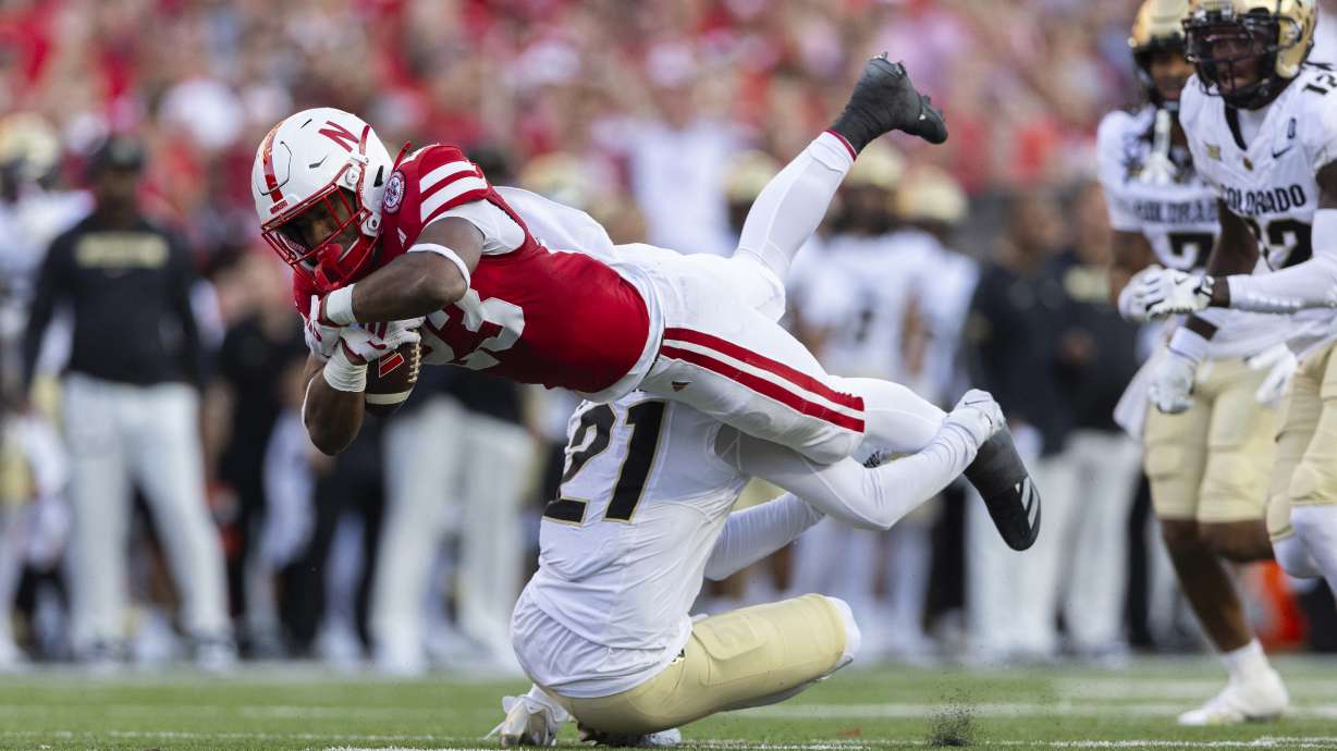 Colorado's Shilo Sanders (21) upends Nebraska's Dante Dowdell, top left, during the first half of an NCAA college football game Saturday, Sept. 7, 2024, in Lincoln, Neb.