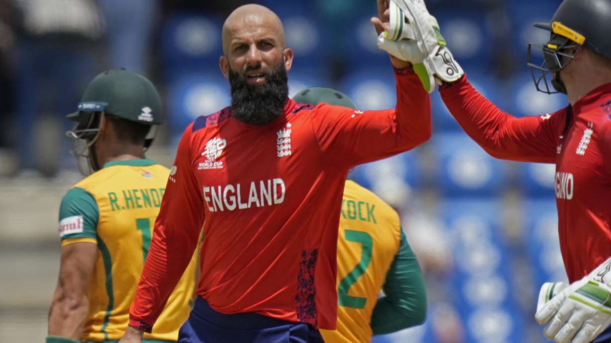 FILE - England's Moeen Ali, center, celebrates with captain Jos Buttler after the dismissal of South Africa's Reeza Hendricks, left, during the ICC Men's T20 World Cup cricket match between England and South Africa at Darren Sammy National Cricket Stadium in Gros Islet, Saint Lucia, Friday, June 21, 2024.