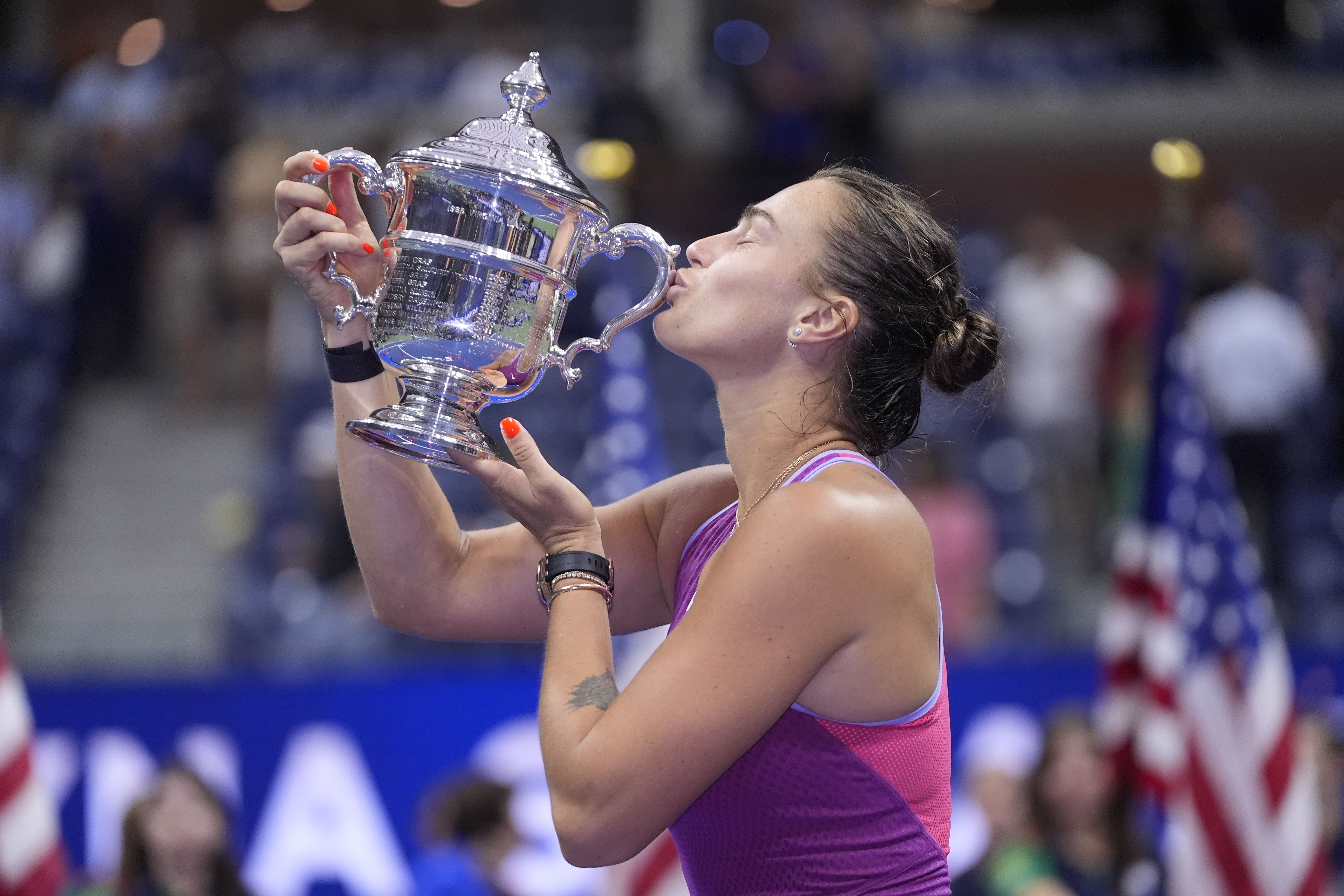 Aryna Sabalenka, of Belarus, kisses the trophy after winning the women's singles final of the U.S. Open tennis championships against Jessica Pegula, of the United States, , Saturday, Sept. 7, 2024, in New York.