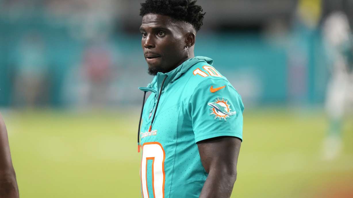 Miami Dolphins wide receiver Tyreek Hill watches from the sideline during the second half of a preseason NFL football game against the Washington Commanders, Saturday, Aug. 17, 2024, in Miami Gardens, Fla.