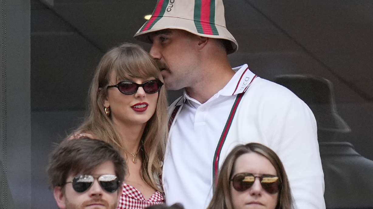 Taylor Swift, left, and Travis Kielce watch play between Jannik Sinner, of Italy, and Taylor Fritz, of the United States, during the men's singles final of the U.S. Open tennis championships, Sunday, Sept. 8, 2024, in New York.