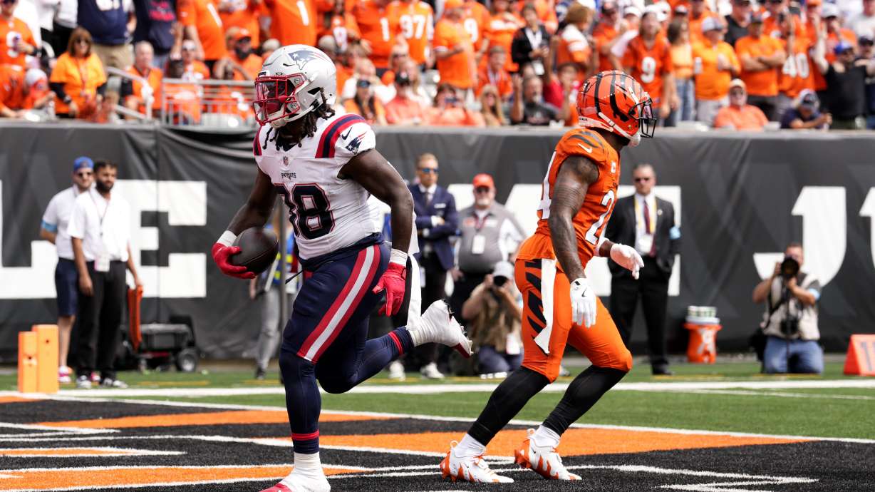 New England Patriots running back Rhamondre Stevenson (38) scores on a 3-yard touchdown run during the first half of an NFL football game against the Cincinnati Bengals, Sunday, Sept. 8, 2024, in Cincinnati.