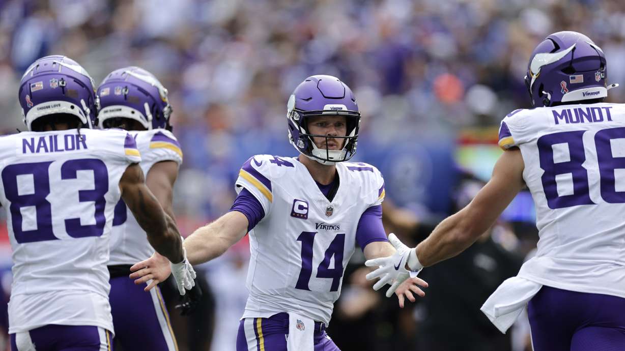 Minnesota Vikings quarterback Sam Darnold (14) celebrates after a 21-yard touchdown catch by teammate wide receiver Jalen Nailor (83) during the second half of an NFL football game against the New York Giants, Sunday, Sept. 8, 2024, in East Rutherford, N.J.