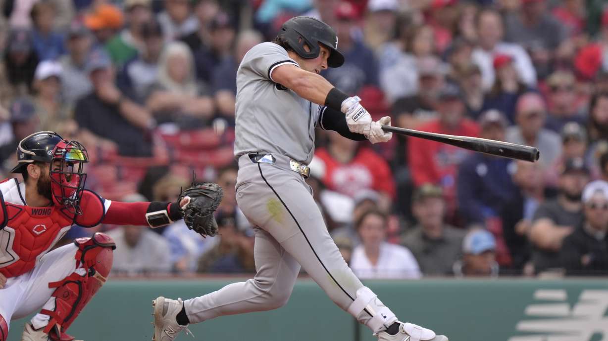 Chicago White Sox's Dominic Fletcher hits a one-run double in front of Boston Red Sox catcher Connor Wong, left, allowing Bryan Ramos to score in the ninth inning of a baseball game , Sunday, Sept. 8, 2024, in Boston.
