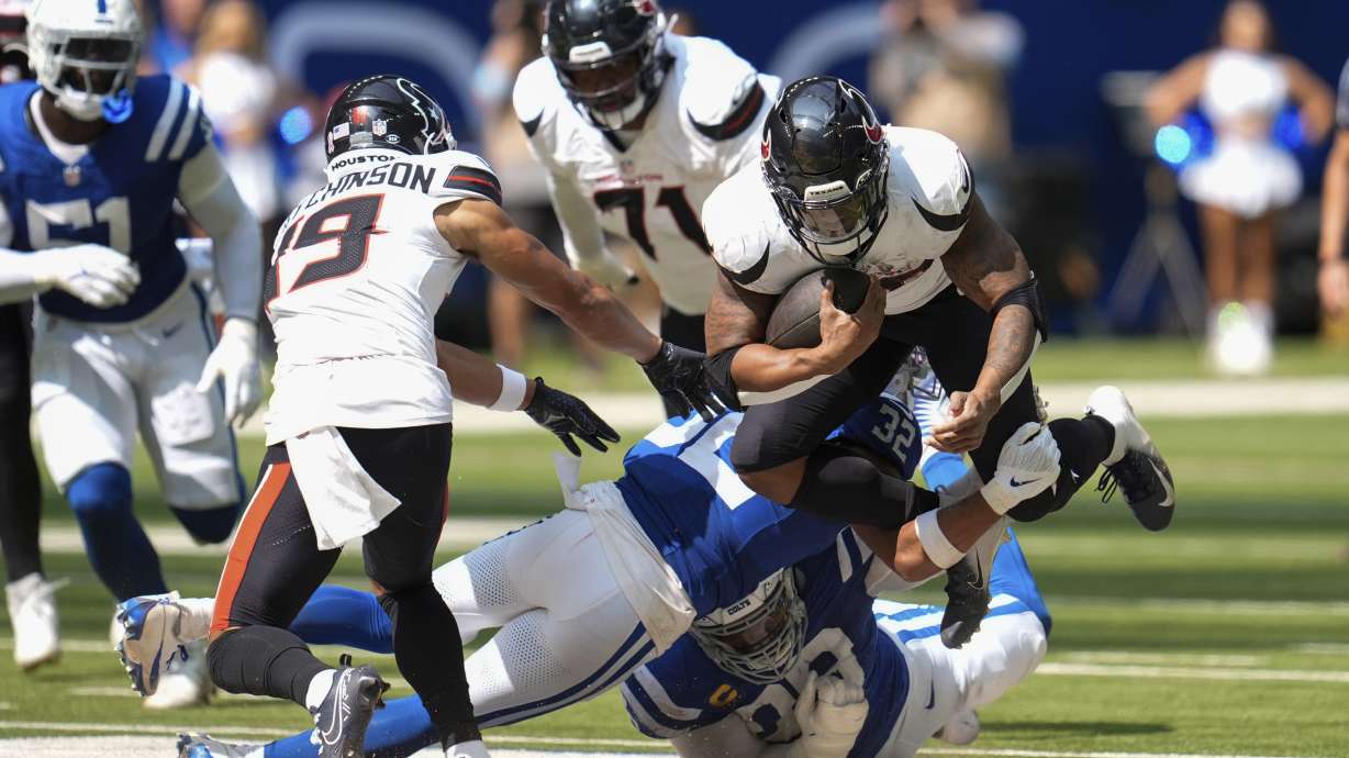Indianapolis Colts safety Julian Blackmon (32) tackles Houston Texans running back Joe Mixon (28) during the second half of an NFL football game, Sunday, Sept. 8, 2024, in Indianapolis.