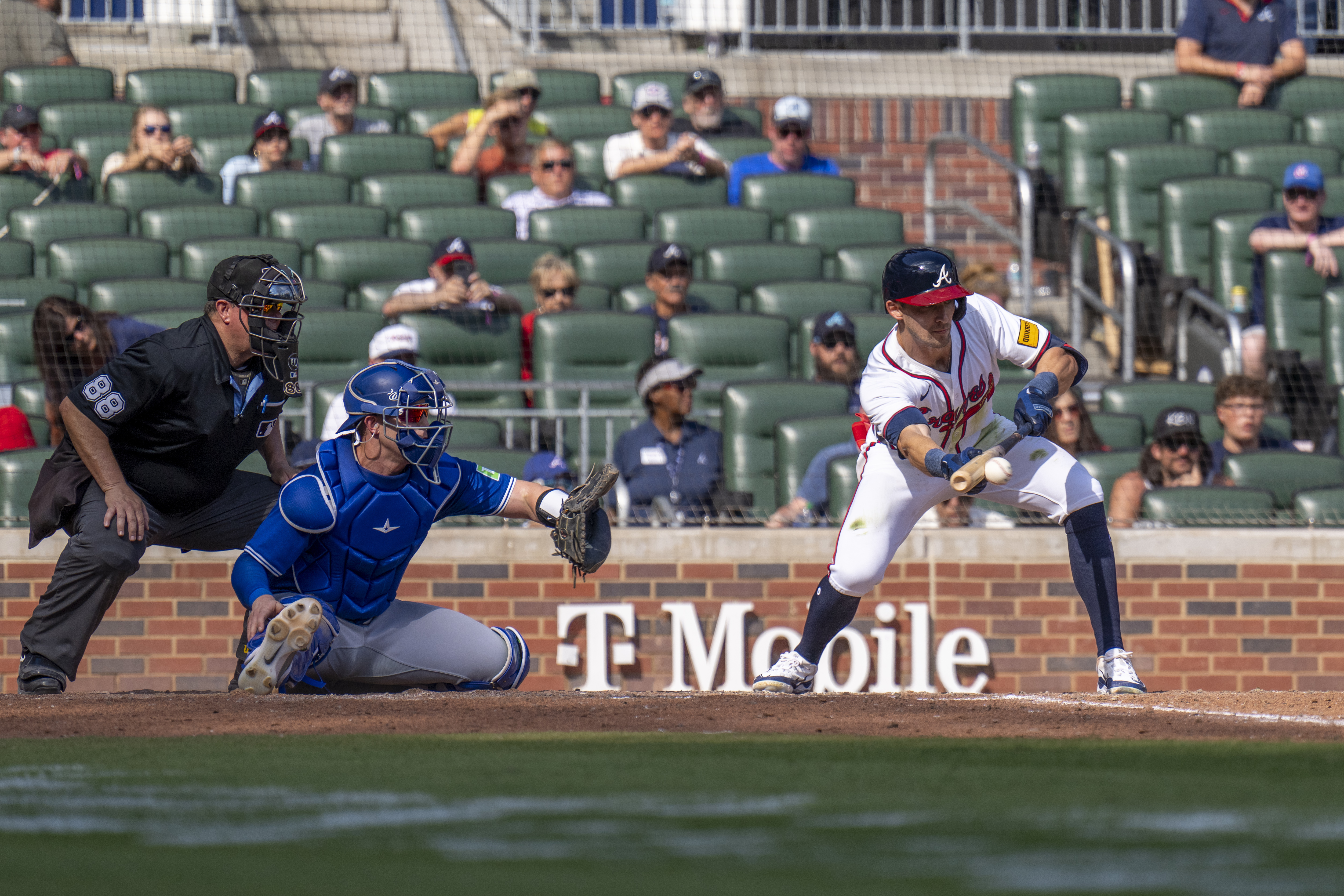 Atlanta Braves outfielder Eli White (36) hits a bunt in the 11th inning of a baseball game between the Toronto Blue Jays and the Atlanta Braves, Sunday, Sept. 9, 2024, in Atlanta.
