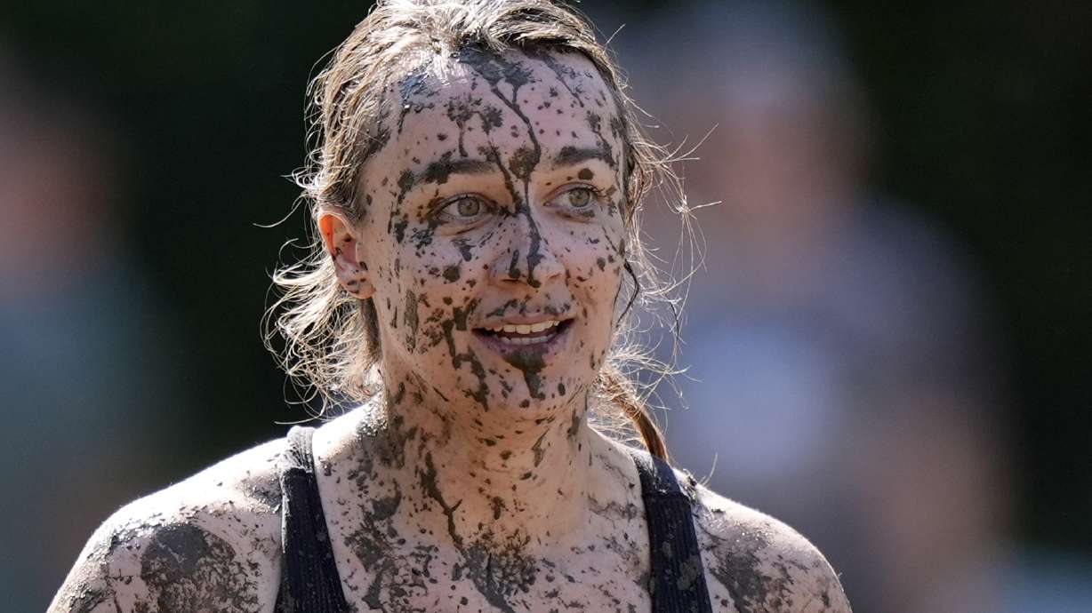 Amanda Lackey, of Bow, N.H., is splattered with mud as she walks back to the huddle during a women's football game at the Mud Bowl in North Conway, N.H., Saturday, Sept. 7, 3024.