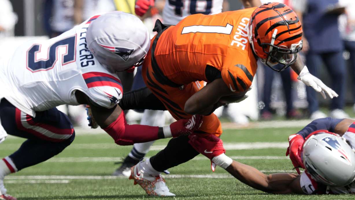 Cincinnati Bengals wide receiver Ja'Marr Chase (1) is tackled by New England Patriots safety Jabrill Peppers (5) after catching a pass during the second half of an NFL football game, Sunday, Sept. 8, 2024, in Cincinnati.