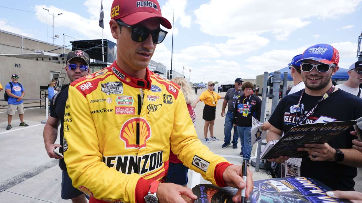 FILE - Joey Logano sings autographs before a practice session for the NASCAR Cup Series auto race at Indianapolis Motor Speedway, Friday, July 19, 2024, in Indianapolis.