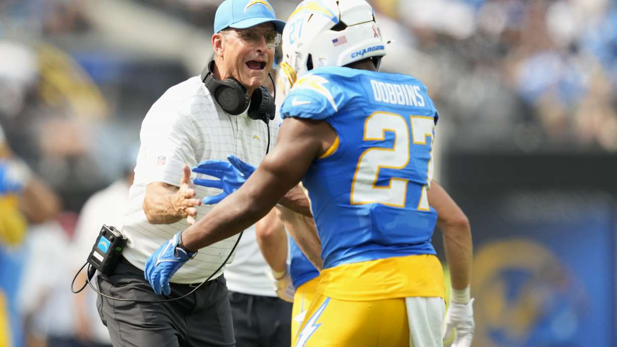 Los Angeles Chargers running back J.K. Dobbins (27) is congratulated by head coach Jim Harbaugh after scoring against the Las Vegas Raiders during the second half of an NFL football game, Sunday, Sept. 8, 2024, in Inglewood, Calif.