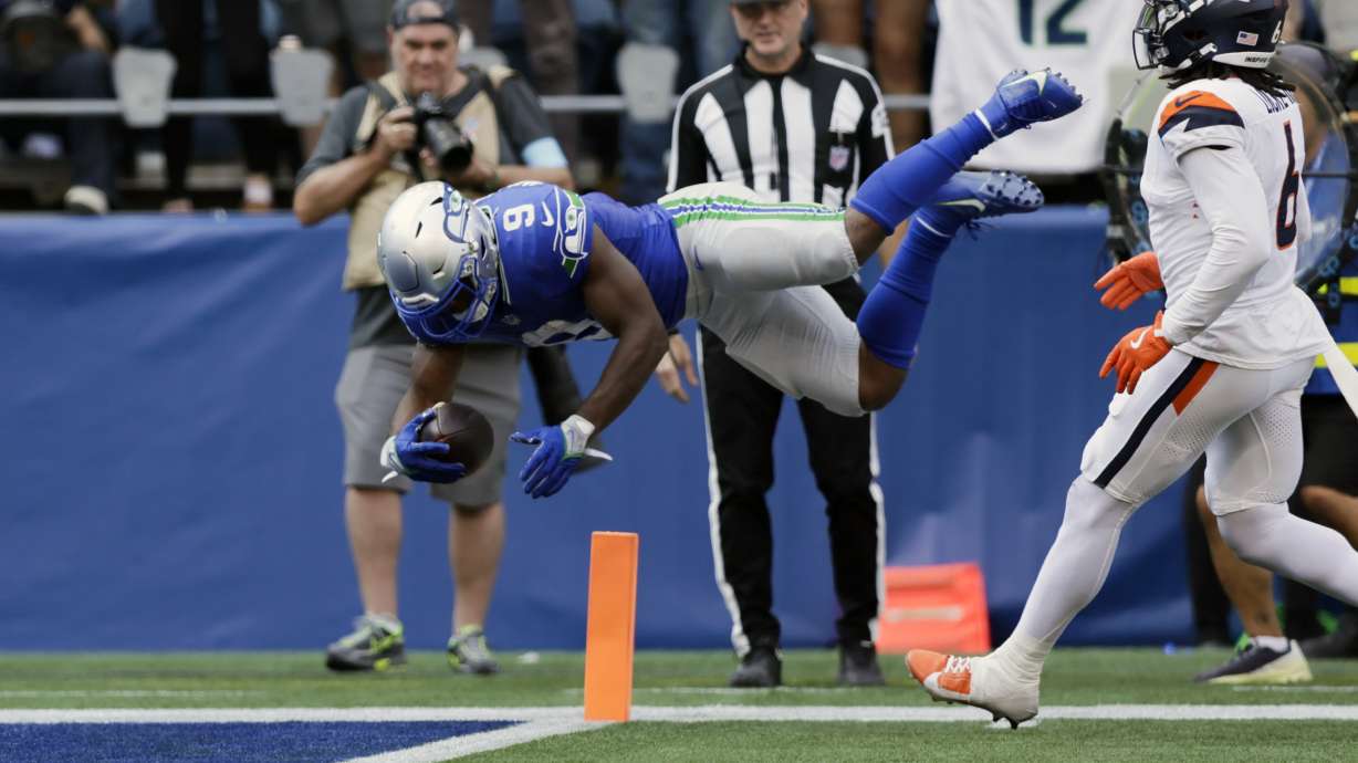Seattle Seahawks running back Kenneth Walker III (9) leaps into the endzone for a touchdown during the second half of an NFL football game against the Denver Broncos, Sunday, Sept. 8, 2024, in Seattle.