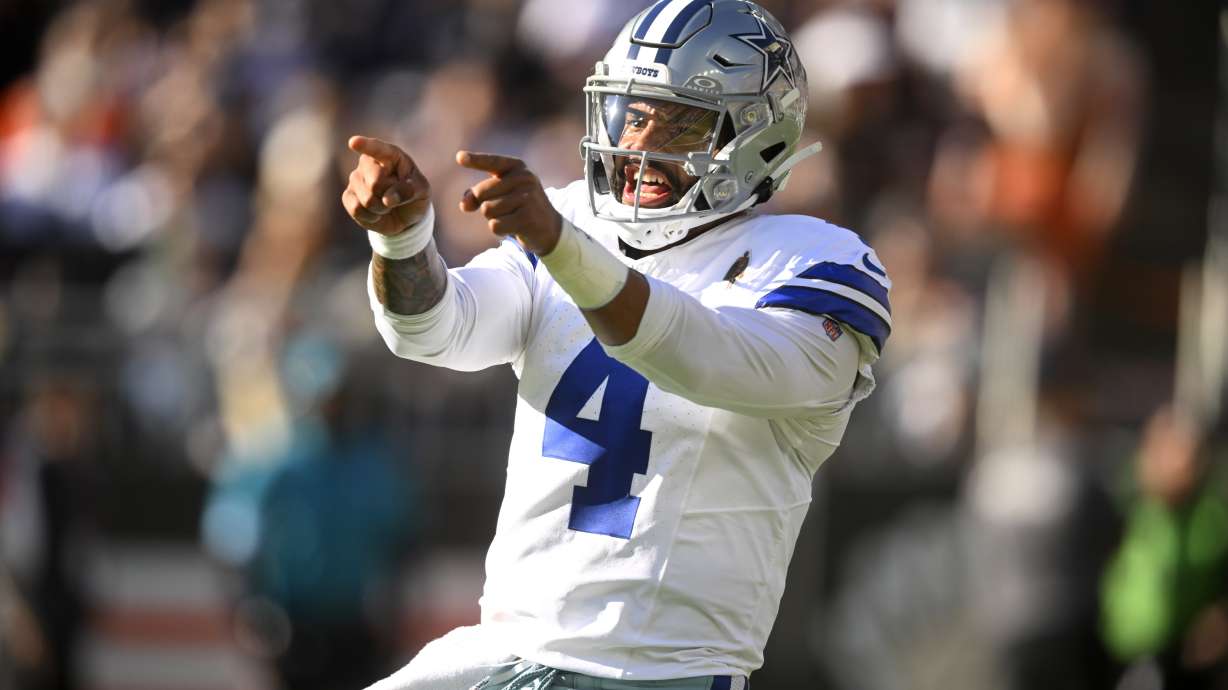 Dallas Cowboys quarterback Dak Prescott celebrates Ezekiel Elliott's touchdown run against the Cleveland Browns in the first half of an NFL football game in Cleveland, Sunday, Sept. 8, 2024.