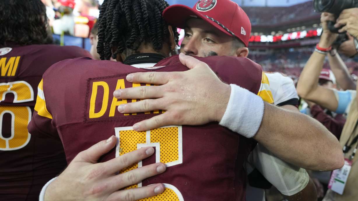 Washington Commanders quarterback Jayden Daniels, left, and Tampa Bay Buccaneers quarterback Baker Mayfield greet each other after an NFL football game Sunday, Sept. 8, 2024, in Tampa, Fla.