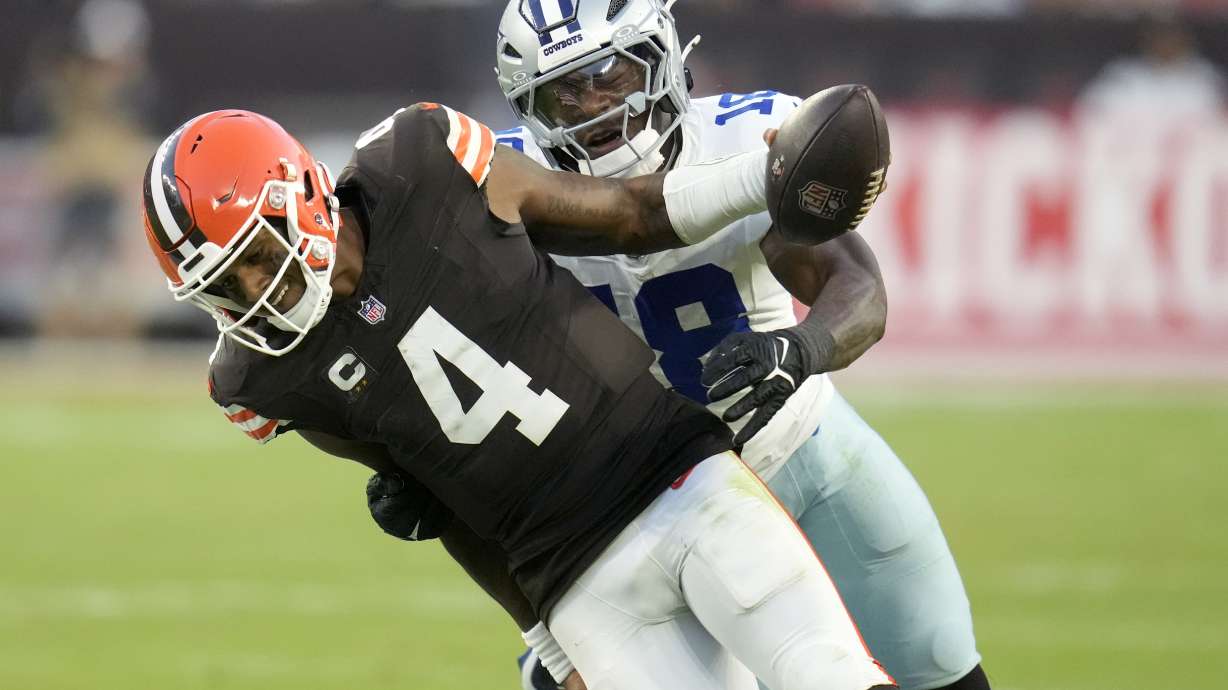 Cleveland Browns quarterback Deshaun Watson (4) runs for a gain before being tackled by Dallas Cowboys linebacker Damone Clark (18) in the second half of an NFL football game in Cleveland, Sunday, Sept. 8, 2024.