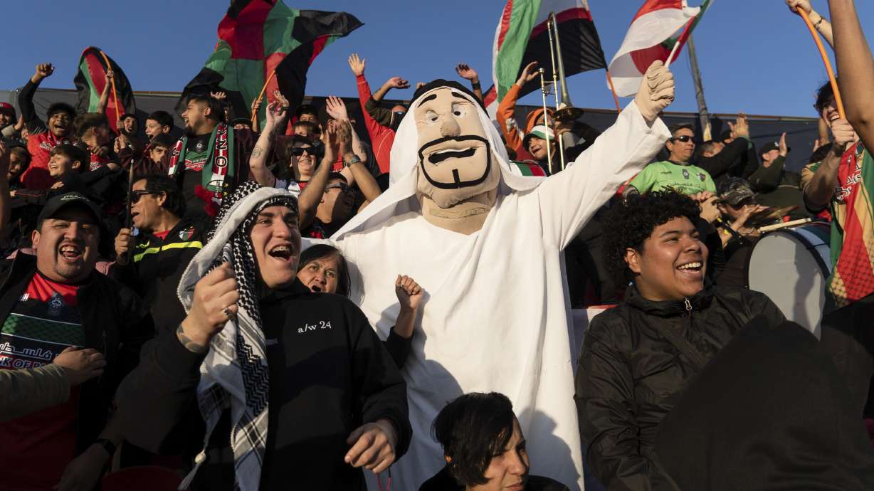 Club Palestino soccer team fans celebrate their victory over Santiago Wanderers at a local league match at La Cisterna stadium in Santiago, Chile, Friday, July 12, 2024.