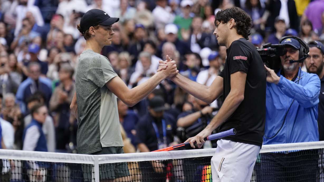 Jannik Sinner, left, of Italy, greets Taylor Fritz, of the United States, after winning the men's singles final of the U.S. Open tennis championships, Sunday, Sept. 8, in New York. 2024.