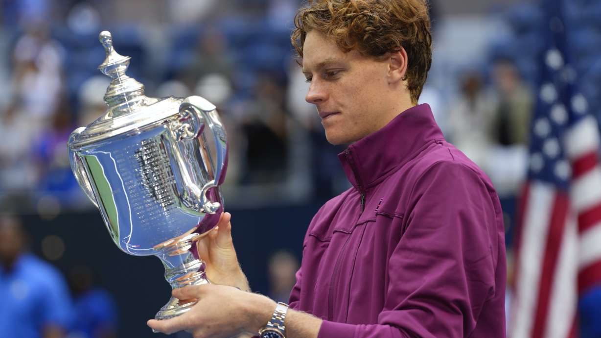 Jannik Sinner, of Italy, holds the championship trophy after defeating Taylor Fritz, of the United States, in the men's singles final of the U.S. Open tennis championships, Sunday, Sept. 8, 2024, in New York.