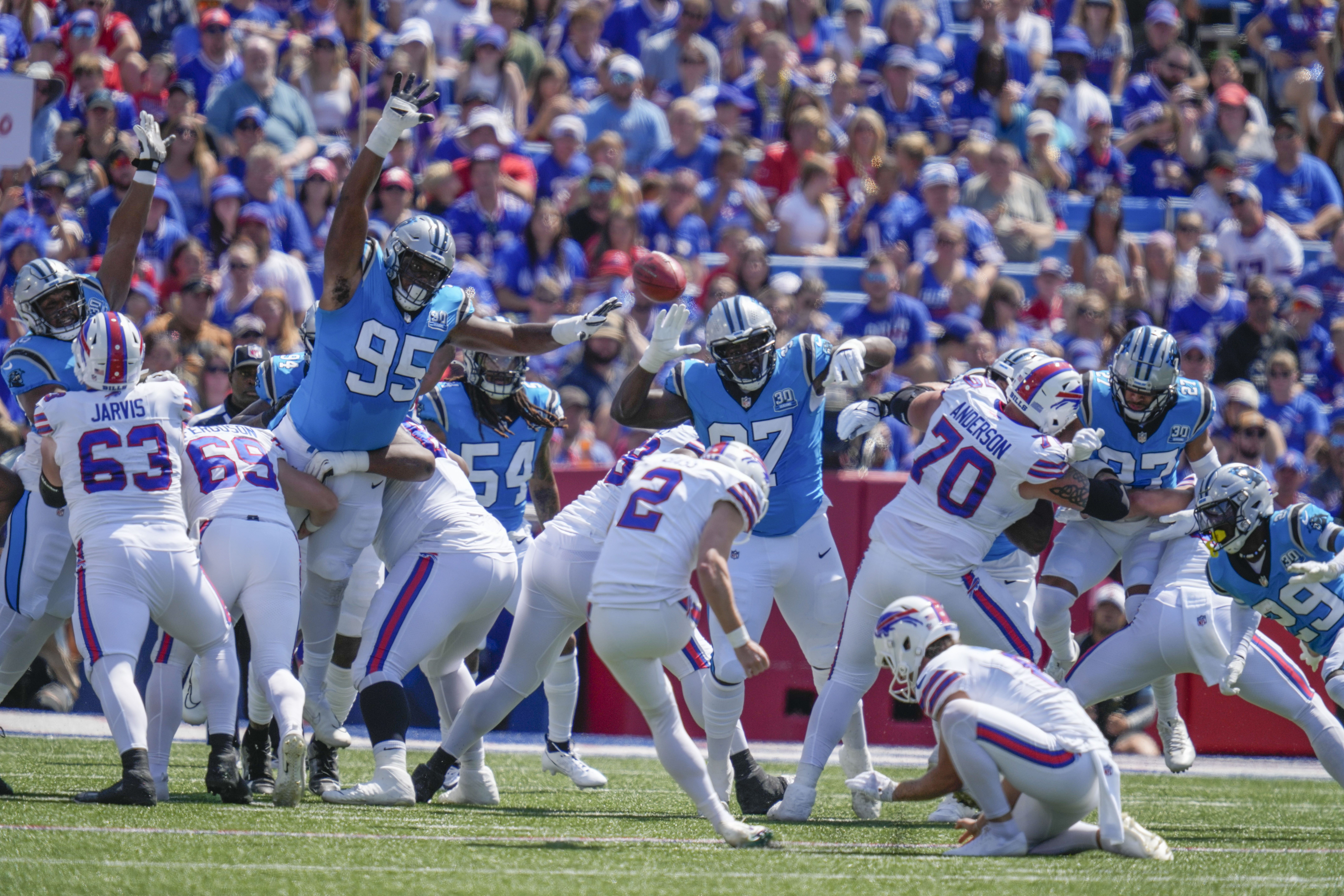 Carolina Panthers defensive end Derrick Brown (95) and defensive tackle T.J. Smith (97) try to block a field goal by Buffalo Bills kicker Tyler Bass (2) in the first half of an NFL preseason football game, Saturday, Aug. 24, 2024, in Orchard Park, N.Y.