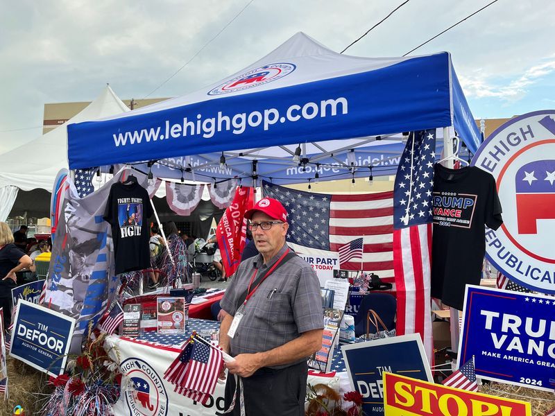 A member of the Lehigh County Republican Committee stands ready to talk with potential voters at the party’s booth at the Great Allentown Fair in Allentown, Pa., Aug. 31.