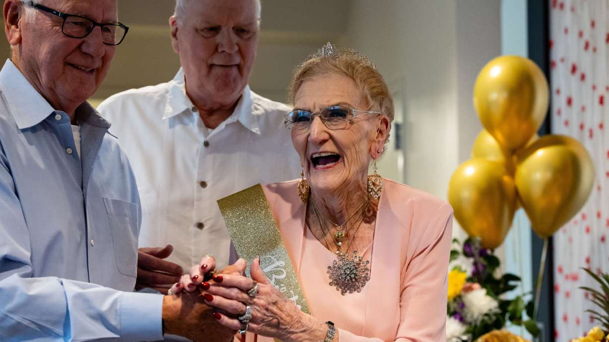 Georgia Presnell, joined by her sons Burt Presnell, left, and Greg Presnell, smiles after blowing out the candles as she celebrates her 105th birthday with family and friends at Treeo, a senior living center, in Orem on June 7. Utah is among the top states in the country on the happiness scale.