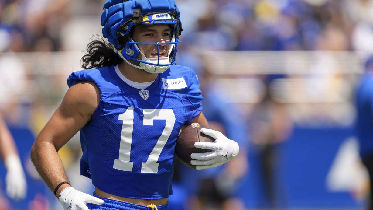 FILE - Los Angeles Rams wide receiver Puka Nacua runs with the ball during the NFL football team's training camp July 27, 2024, at Loyola Marymount University in Los Angeles.