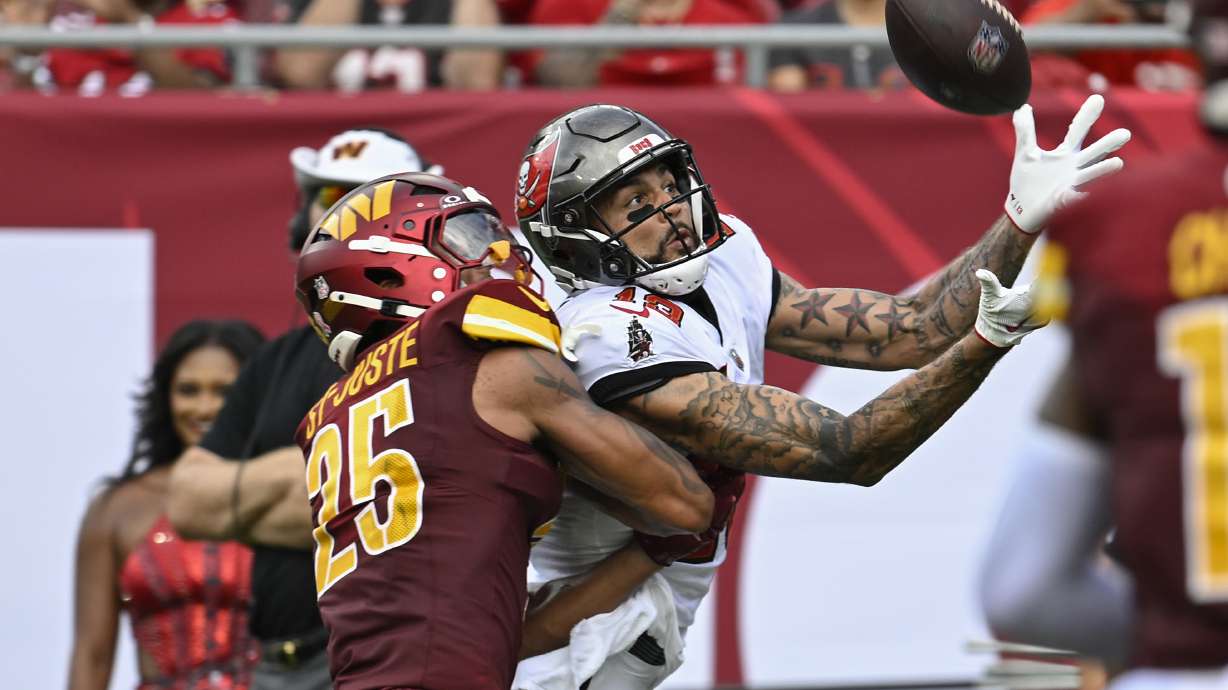 Tampa Bay Buccaneers wide receiver Mike Evans, right, makes a reception for a touchdown in front of Washington Commanders cornerback Benjamin St-Juste (25) during the first half of an NFL football game Sunday, Sept. 8, 2024, in Tampa, Fla.