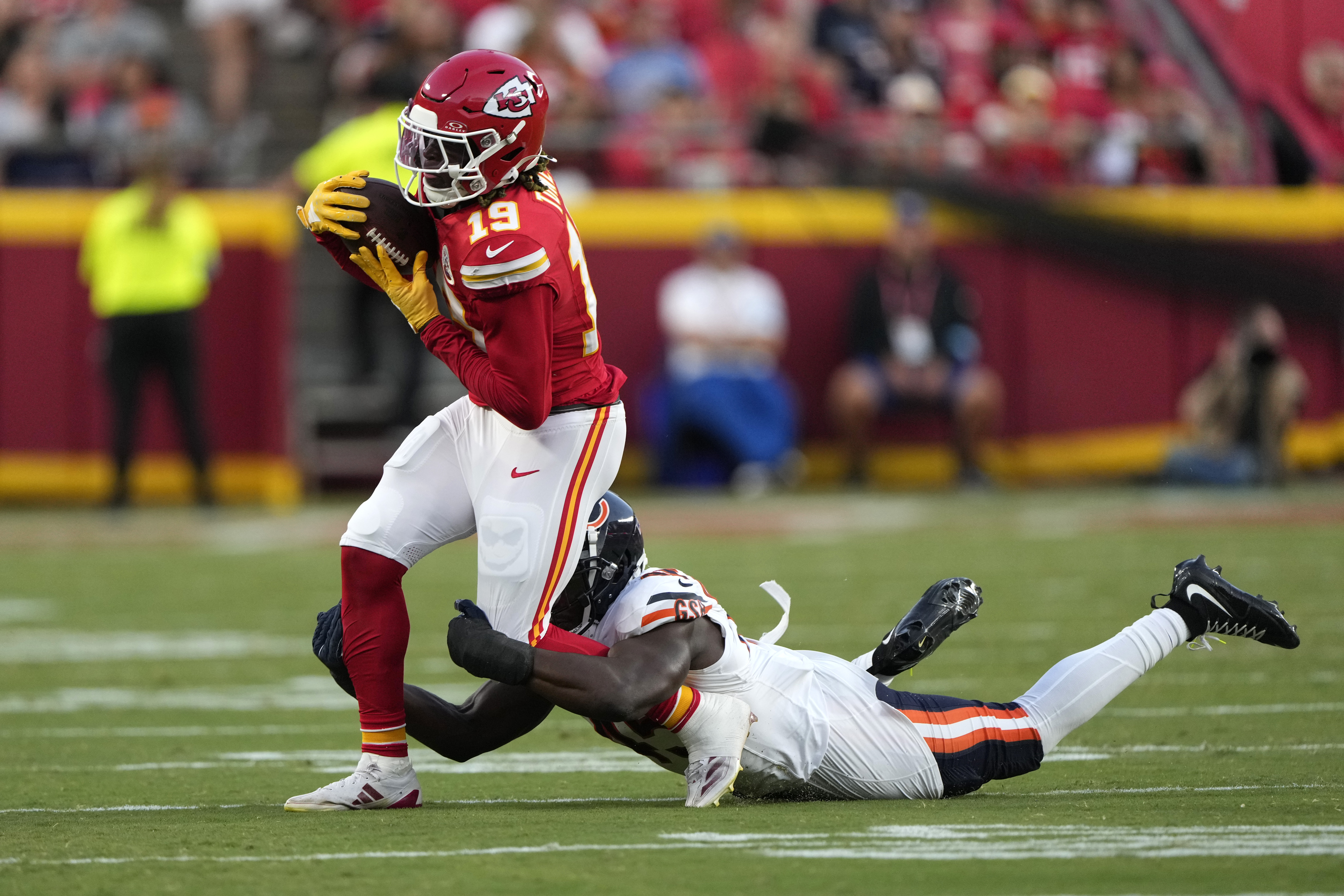 Kansas City Chiefs wide receiver Kadarius Toney (19) catches a pass as Chicago Bears linebacker Amen Ogbongbemiga defends during the first half of an NFL preseason football game Thursday, Aug. 22, 2024, in Kansas City, Mo.