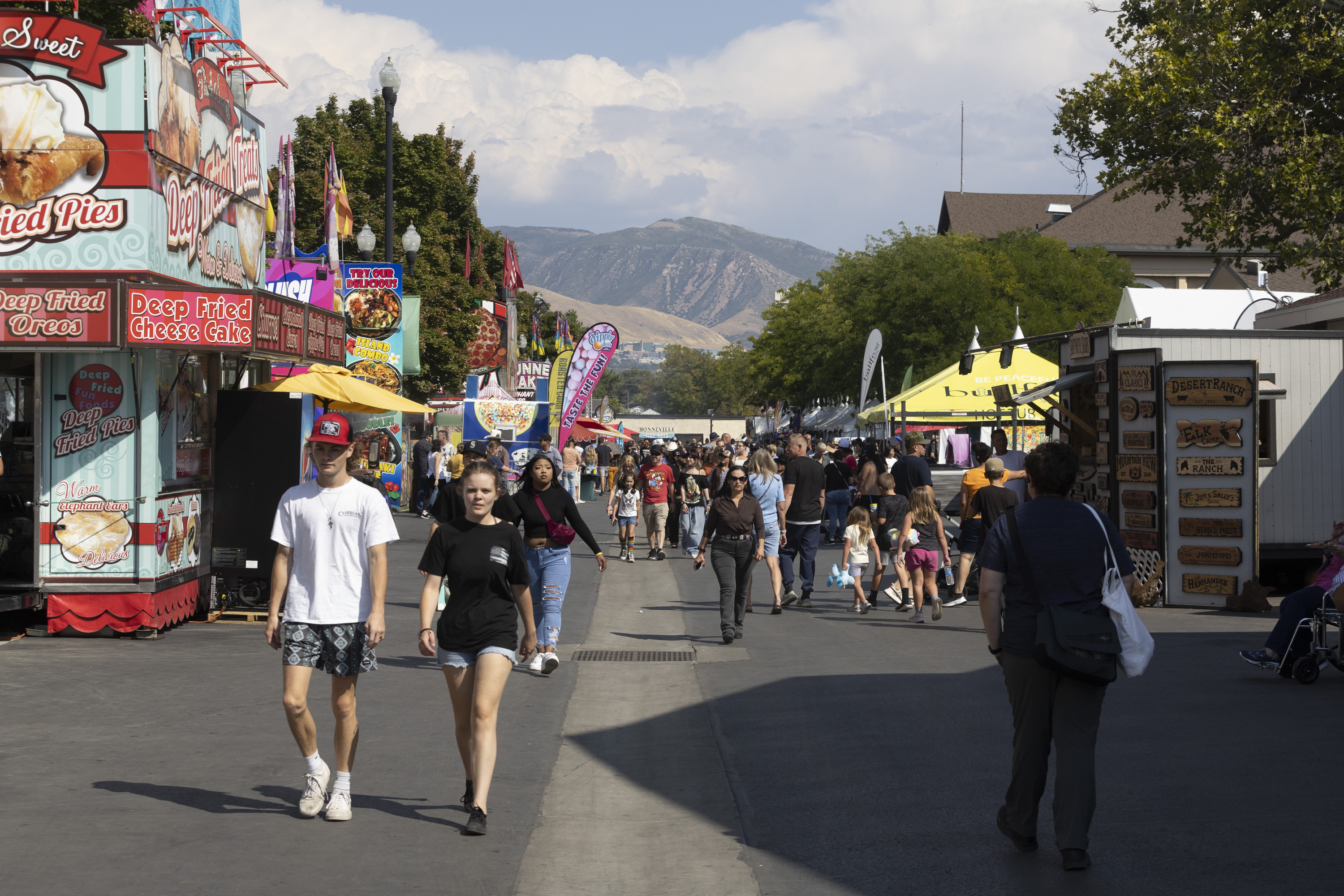 People walk down a thoroughfare during the Utah State Fair at the Utah State Fairpark in Salt Lake City on Sunday.