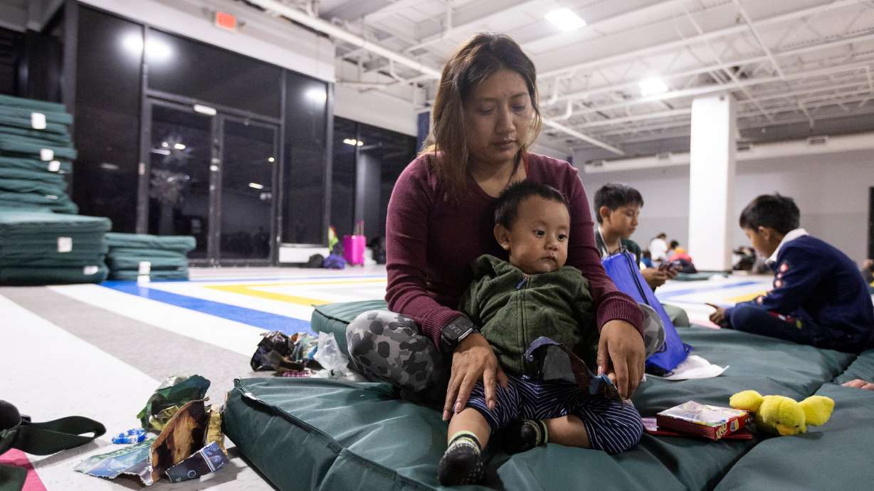 Immigrant Nancy Toaquiza is seen with her son Aarón at Catholic Charities in McAllen, Texas, on June 17. Donald Trump and Kamala Harris share some views on entitlement programs and immigration.