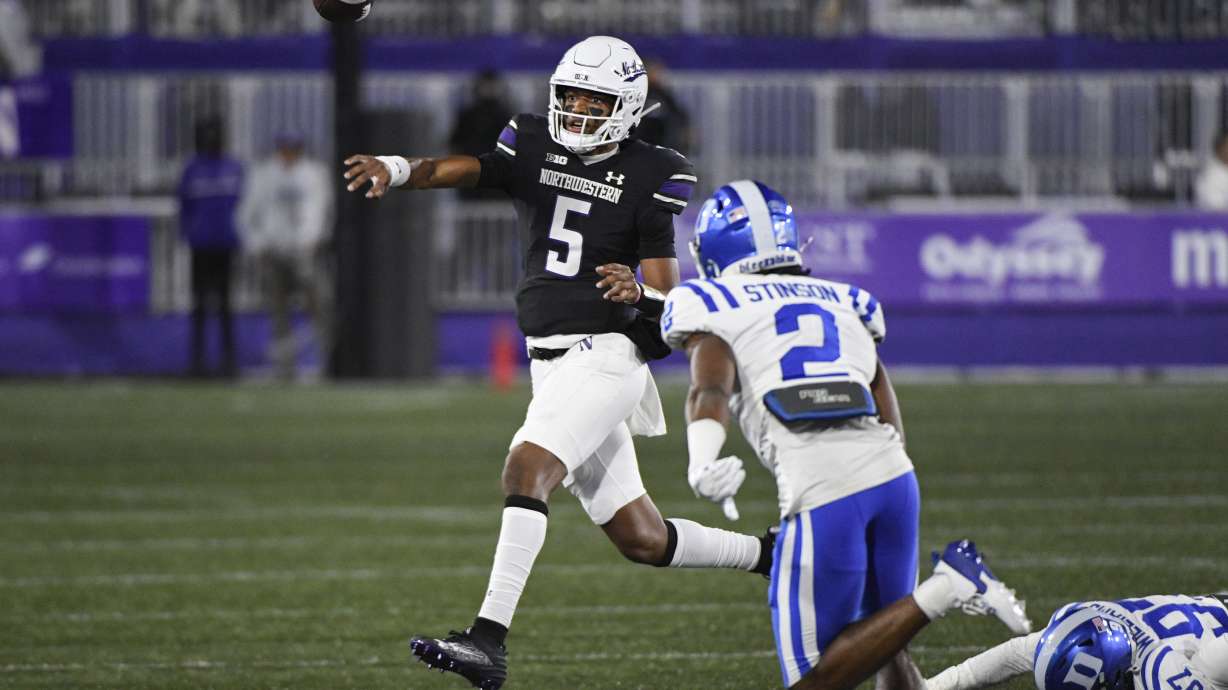 Northwestern quarterback Mike Wright (5) passes the ball against Duke safety Jaylen Stinson (2) during the first half of an NCAA college football game, Friday, Sept. 6, 2024, in Evanston, Ill.