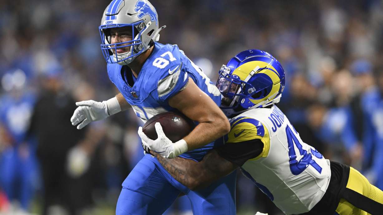 Detroit Lions tight end Sam LaPorta (87) runs after a catch as Los Angeles Rams safety John Johnson III (43) makes the tackle during the first half of an NFL football game in Detroit, Sunday, Sept. 8, 2024.