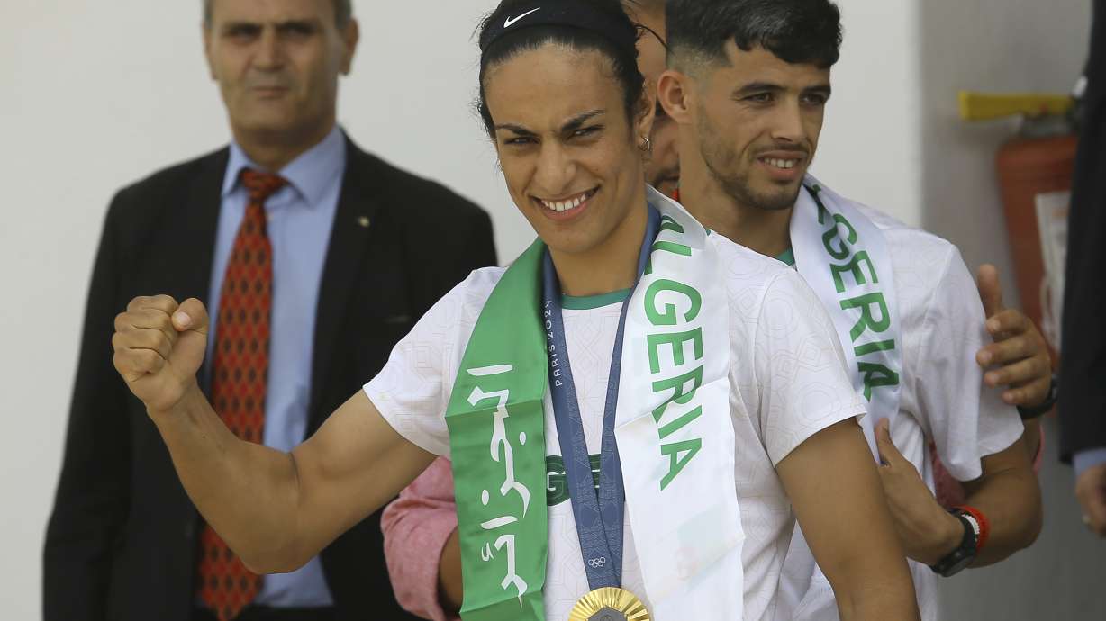 Gold medalist in the the women's 66 kg boxing Algeria's Imane Khelif, left, and bronze medalist in the men's 800m Djamel Sedjati arrive after the 2024 Summer Olympics, Monday, Aug. 12, 2024, at Algiers airport, Algeria.