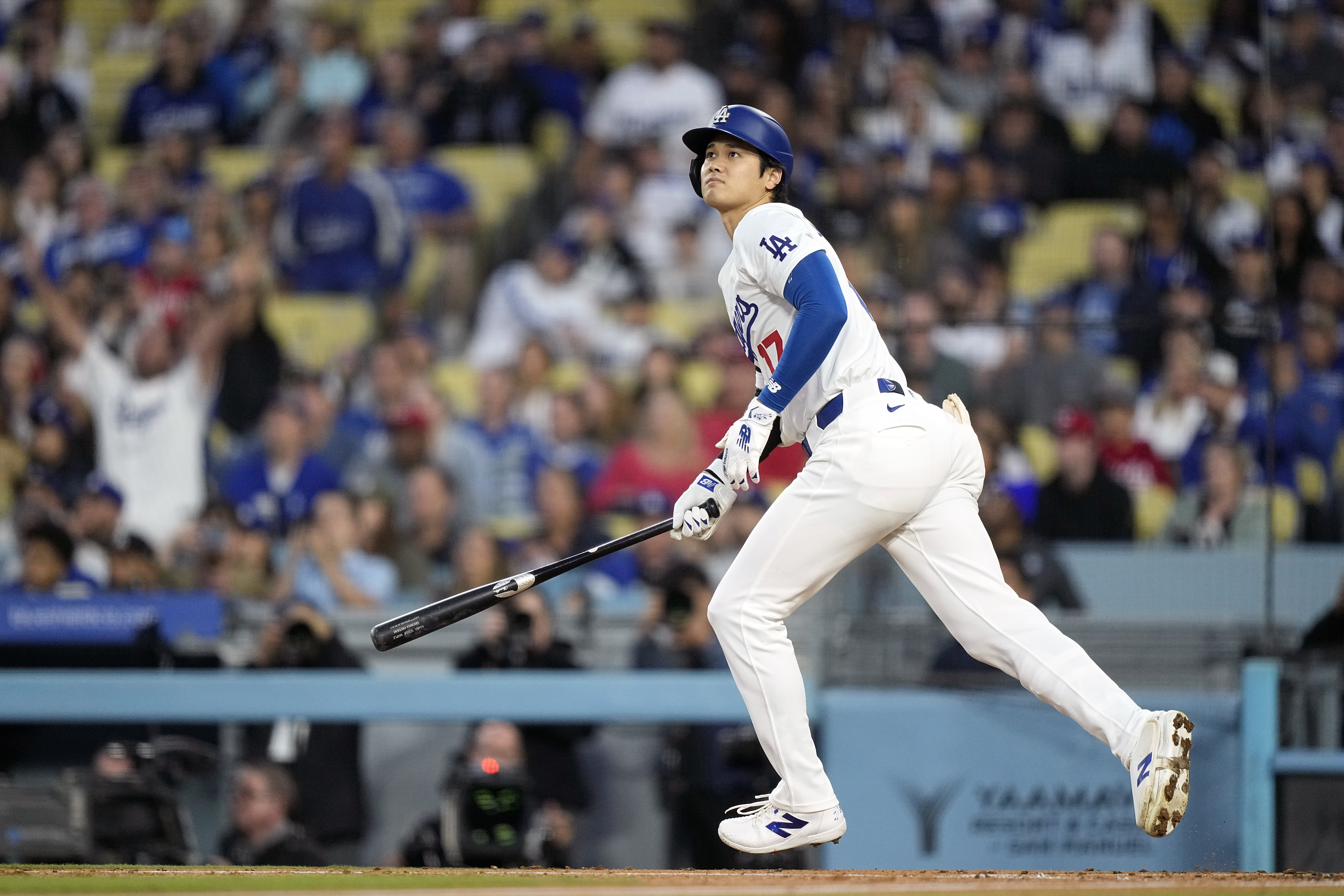 Los Angeles Dodgers designated hitter Shohei Ohtani heads to first after hitting a two-run home run during the third inning of a baseball game against the Cincinnati Reds Friday, May 17, 2024, in Los Angeles.