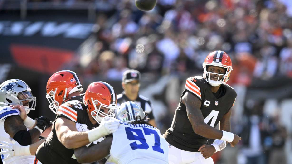 Cleveland Browns quarterback Deshaun Watson (4) throws a pass under pressure from Dallas Cowboys defensive tackle Osa Odighizuwa (97) in the first half of an NFL football game in Cleveland, Sunday, Sept. 8, 2024.