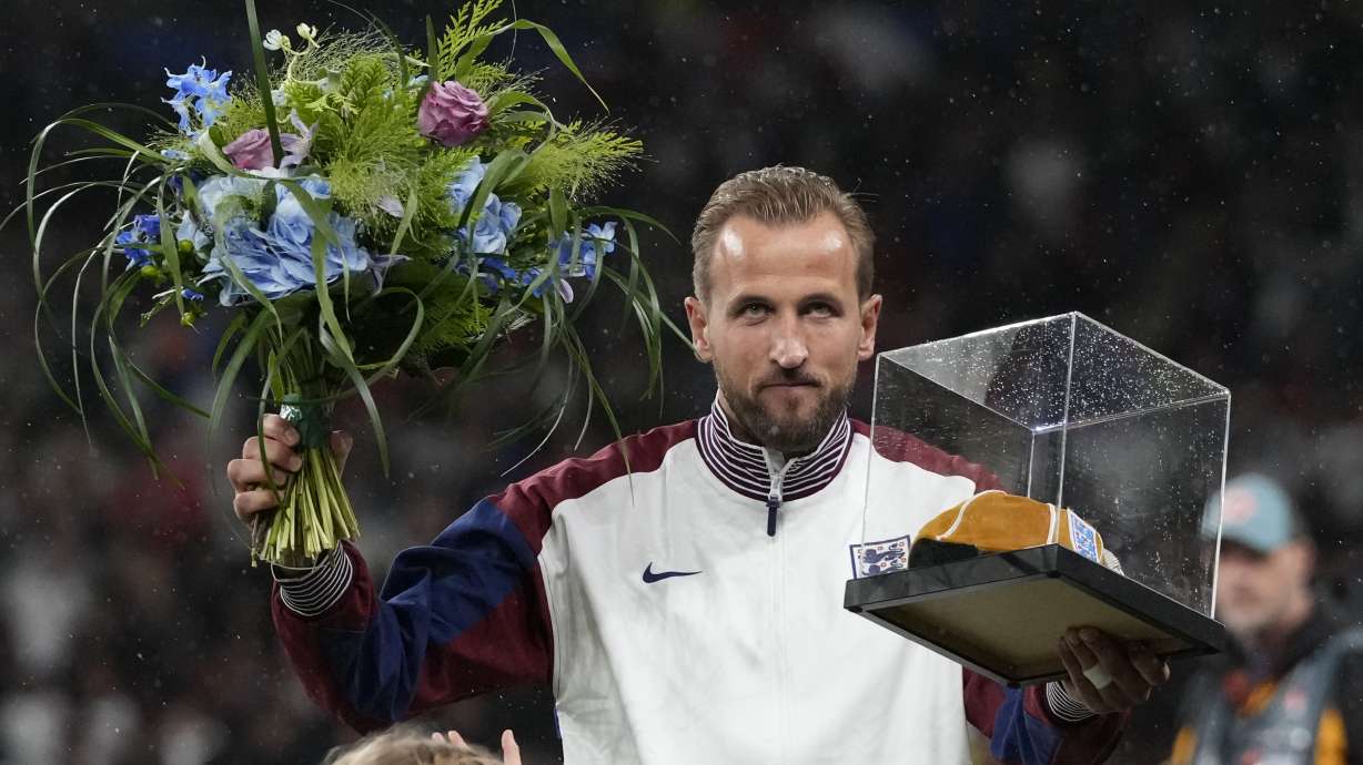 England's Harry Kane poses with award for his hundredth match the Group F UEFA Nations League soccer match between England and Finland at Wembley Stadium in London, Tuesday, Sept. 10, 2024.